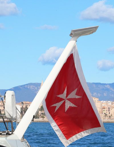 Carbon composite Starlink flagpole mount (V2) installed on a yacht with flag and marine background