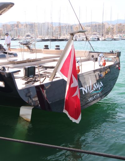 Starlink antenna mounted on composite flagpole mount at sailing yacht.